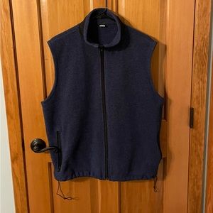 Men’s blue fleece vest with zip pockets and bottom cinch